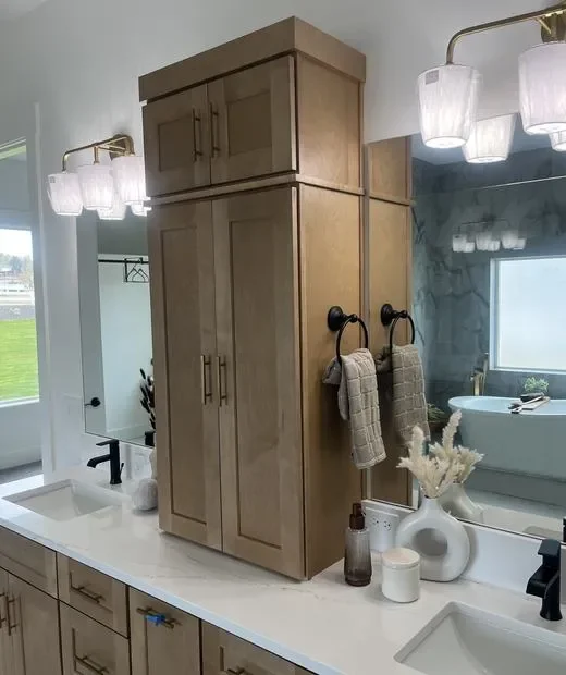 Custom wood bathroom vanity with tall storage tower, shaker doors, and white quartz countertop