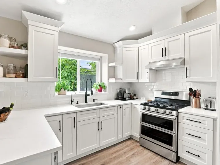 White shaker cabinets, quartz countertops, subway tile backsplash, stainless steel appliances